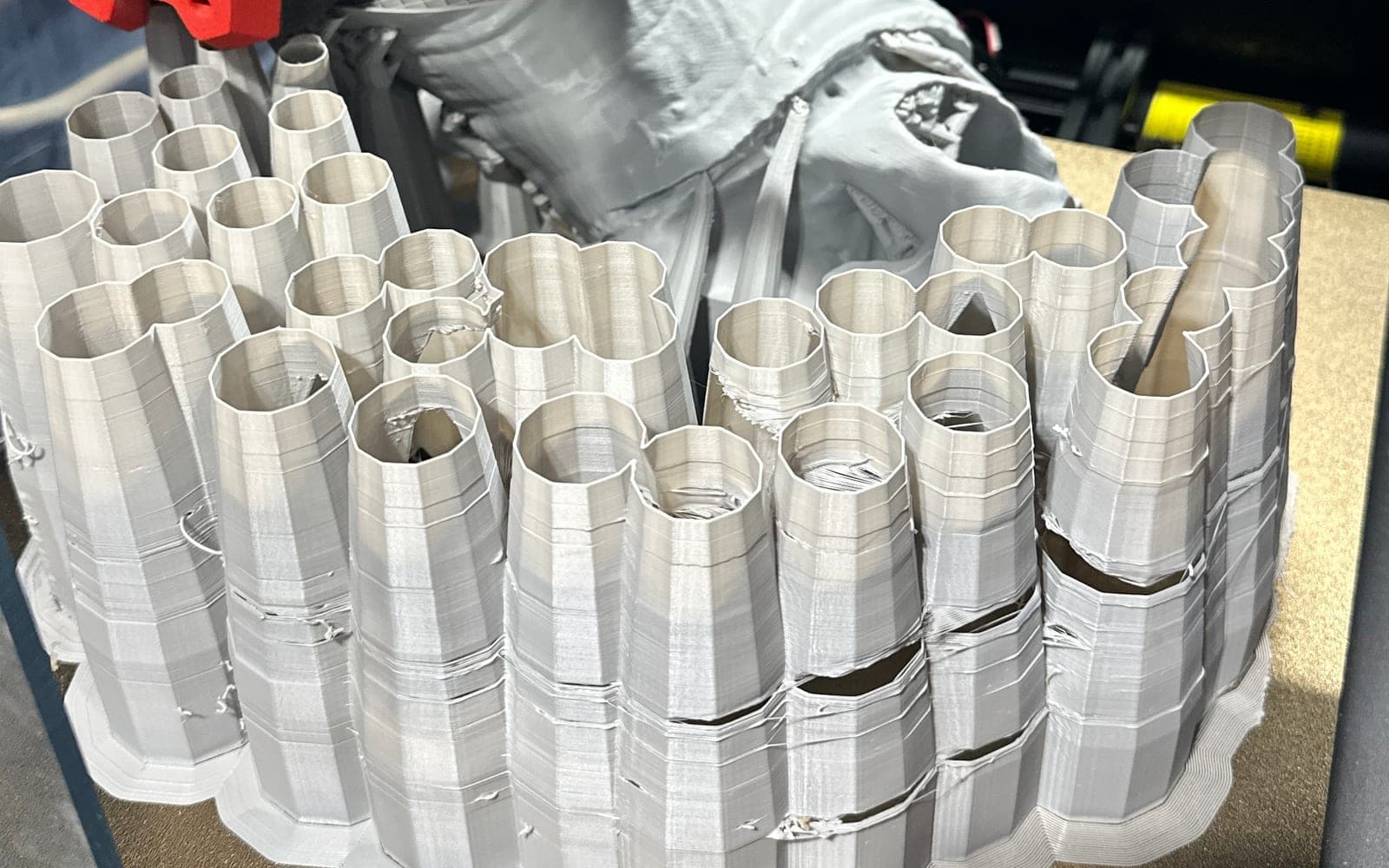 Large white multi-part 3D print on a printer bed