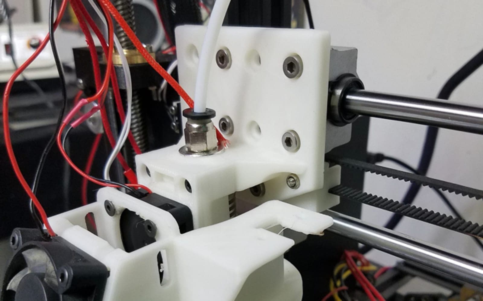 White functional 3D printed toolhead mount installed on a printer