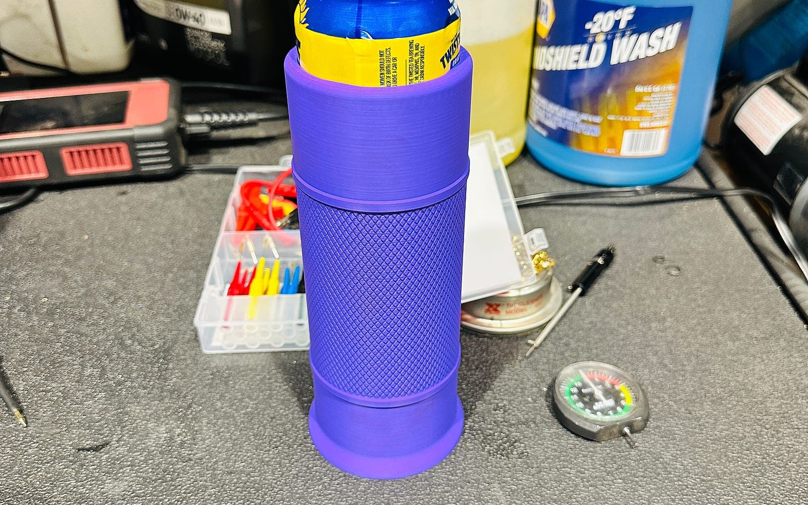 Purple functional 3D printed holder on a shop workbench