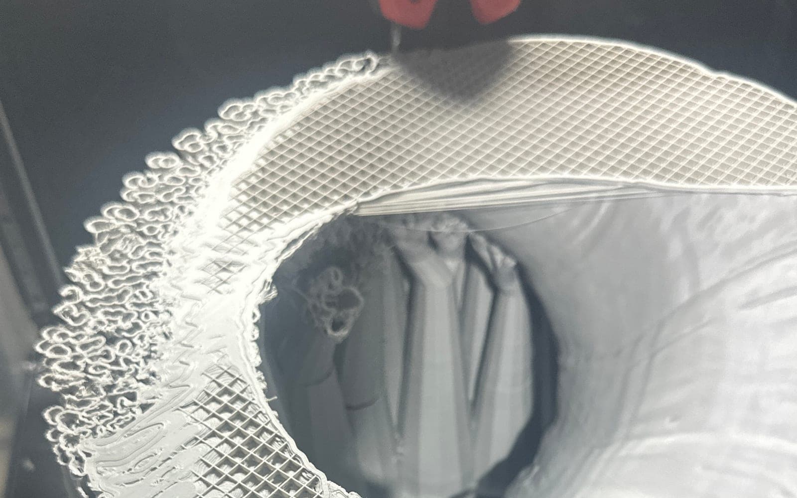 White support-heavy display prop being 3D printed on a printer bed